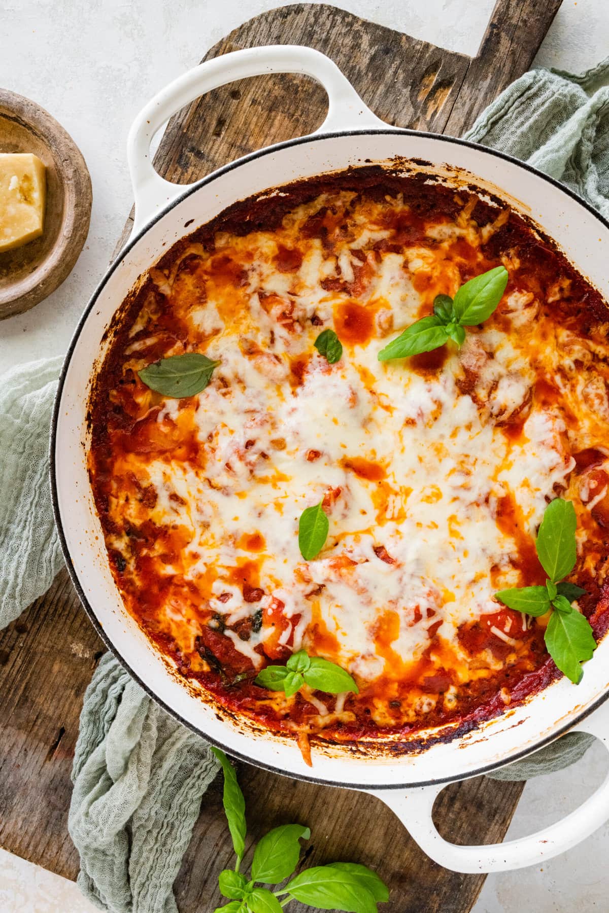 How to make gnocchi all sorrentina step-by-step- mixing gnocchi with sauce. Topping with cheese. Baking in oven.