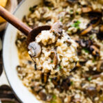 finished risotto super creamy on a wooden spoon.