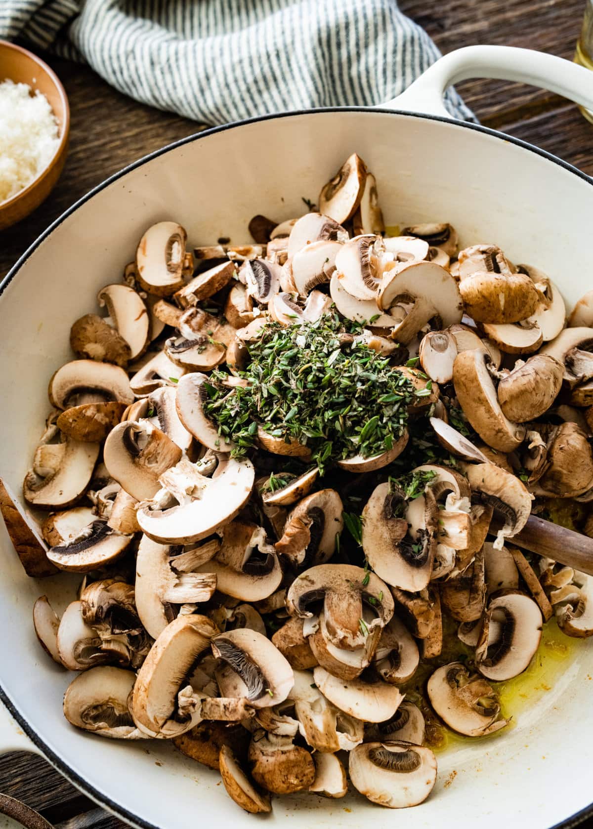 How to Make Creamy Mushroom Risotto Instructions- add the mushrroms and herbs to the pan.