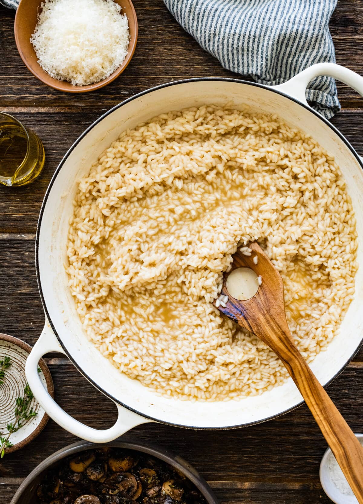 How to Make Creamy Mushroom Risotto Instructions- stirring the risotto and stirring.