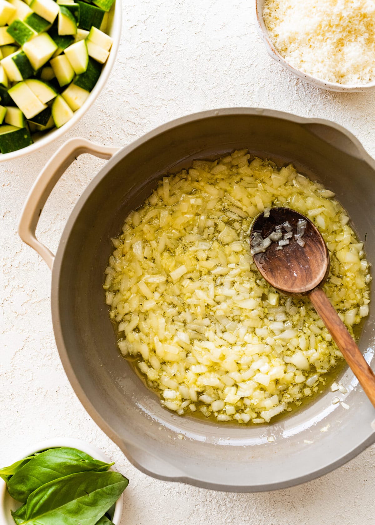 Step by step instructions Fregola Sarda Pasta Recipe with Zucchini and Cheese- onions in pan with olive oil.