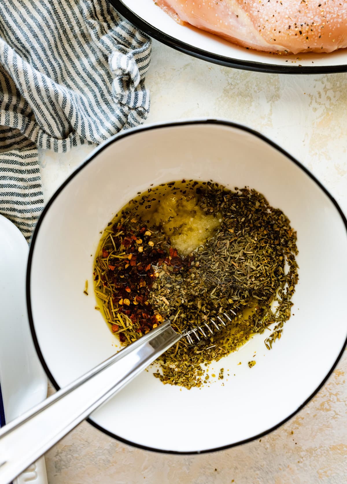 mixing the herbs and the olive oil in a bowl.