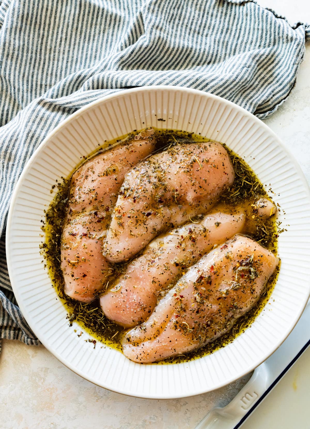 massaging the chicken with the olive oil and herbs.