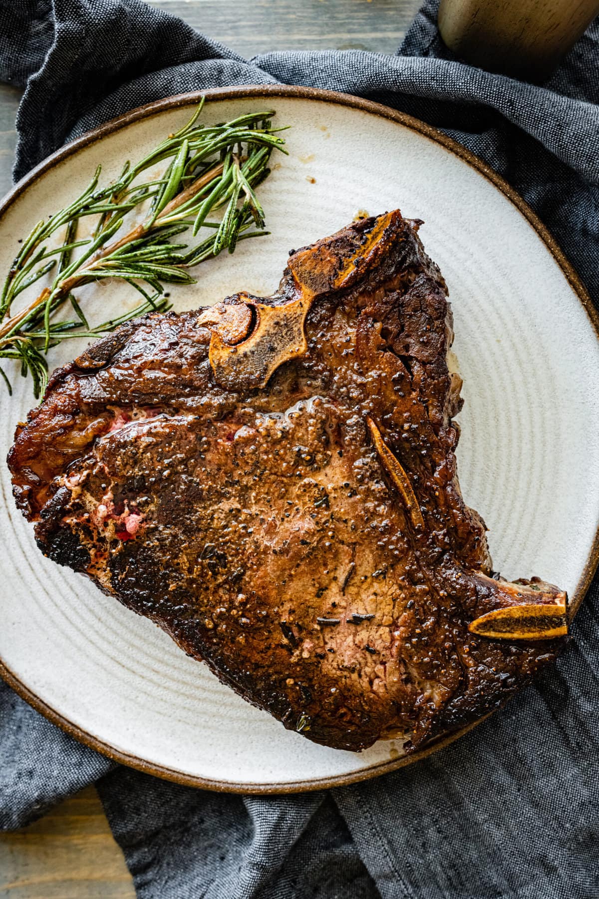 T-bone steak on a plate ready to cut.