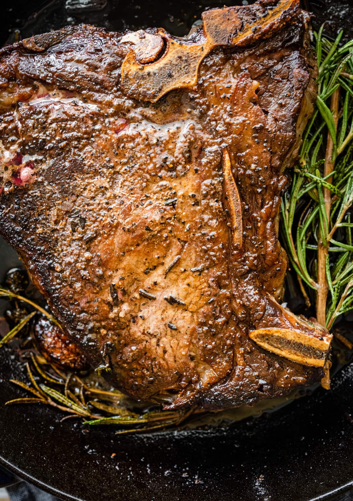 How to Cook T-Bone Steak in Pan Instructions- close up of cooked steak in a pan.