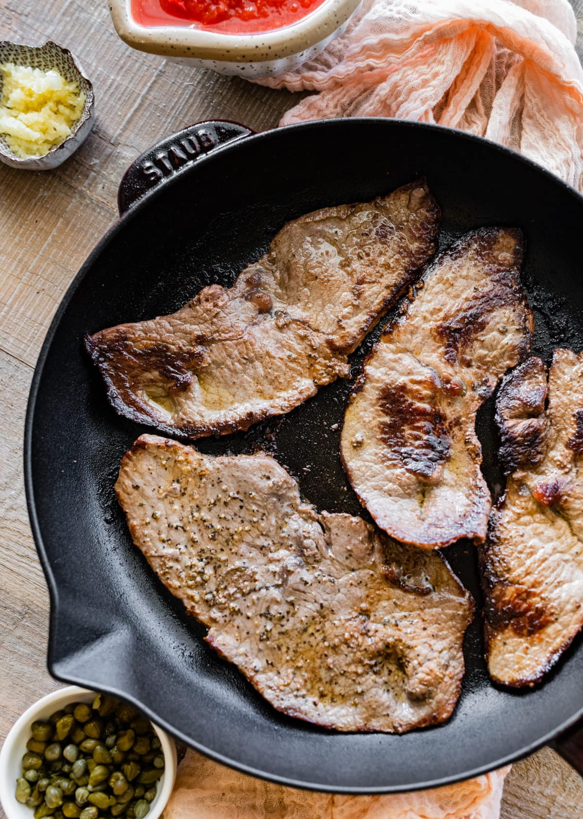 How to make steak pizzaiola step by step- frying steak in a pan.