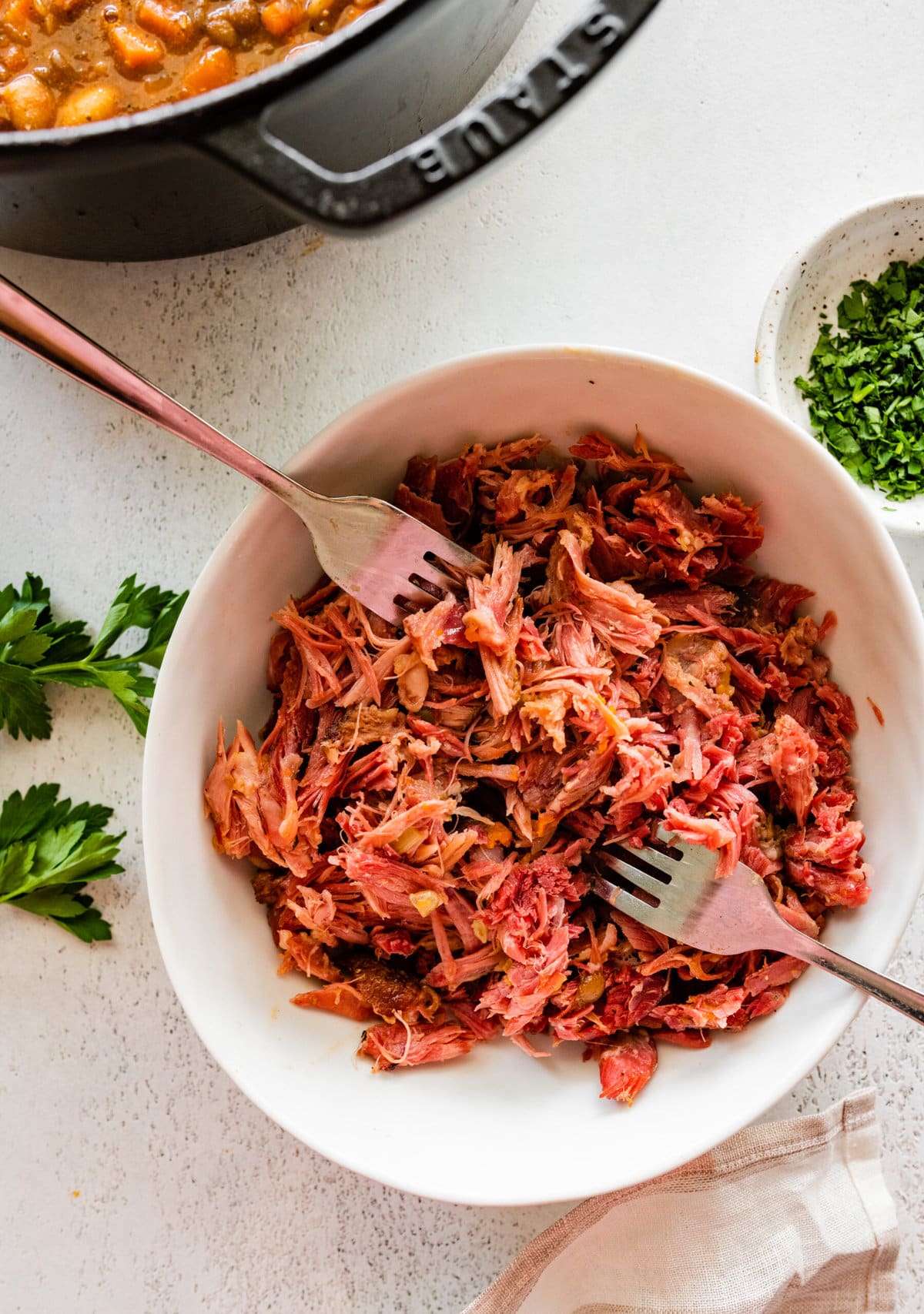 how to make 15 bean soup mix recipe with ham Step by Step: taking out the ham from the ham hock and shredding it in a separate bowl.