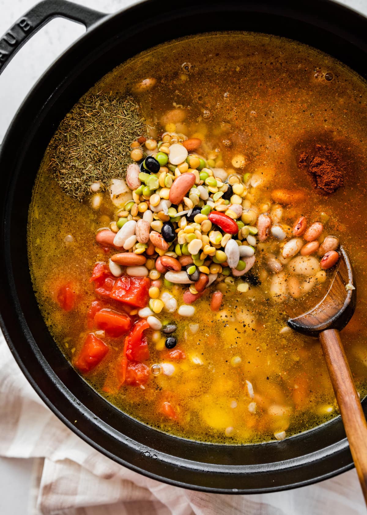 how to make 15 bean soup mix recipe with ham Step by Step: adding beans, spices, and tomatoes to the pot.
