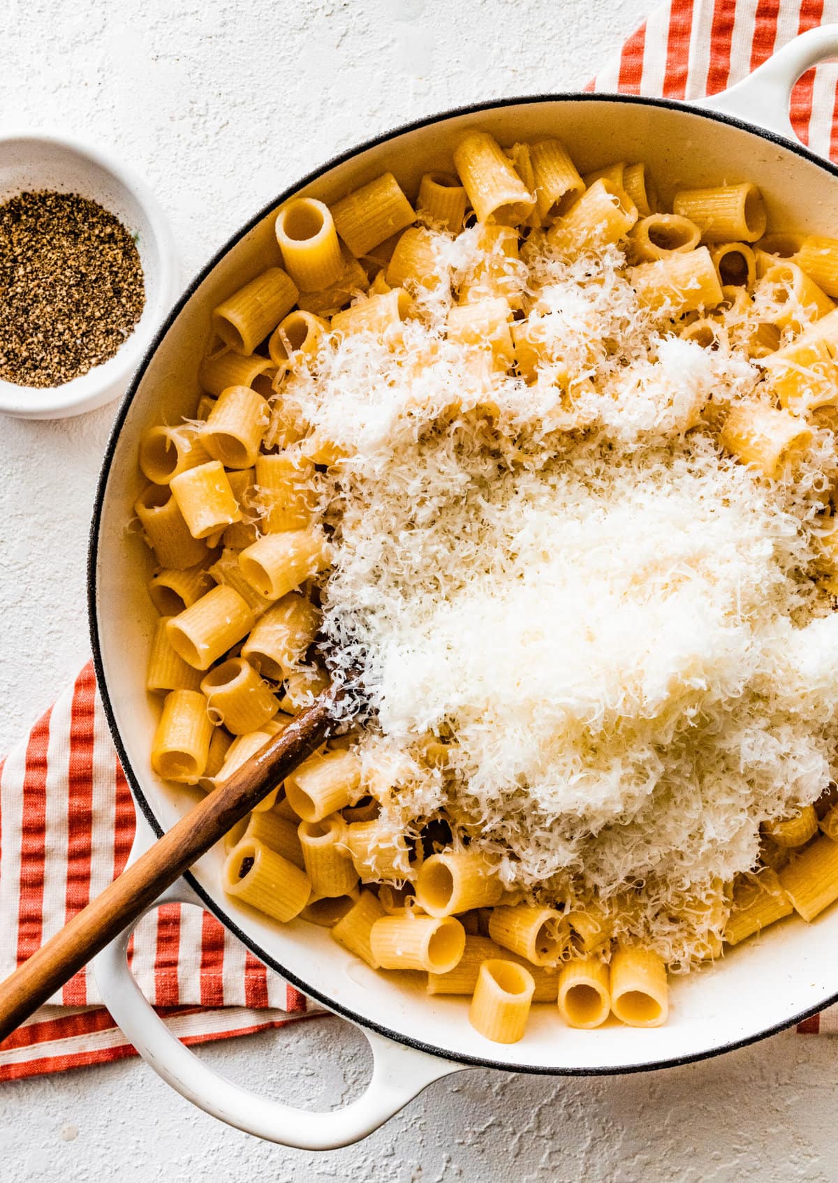 How to make authentic pasta alla gricia step-by-step: add cheese to the pasta.