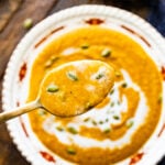 Autumn Squash Soup Recipe (Panera Copycat) in a beautiful bowl with spoon showing up close of soup.