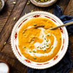 Autumn Squash Soup Recipe (Panera Copycat) in a beautiful bowl with spoon showing up close of soup.