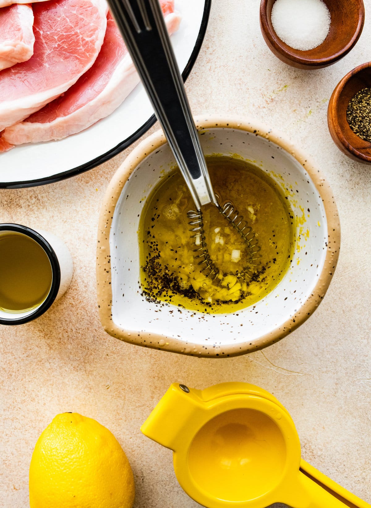 How to Make Best Juicy Thin Pork Chops Step by Step: mixing marinade ingredients in a bowl.