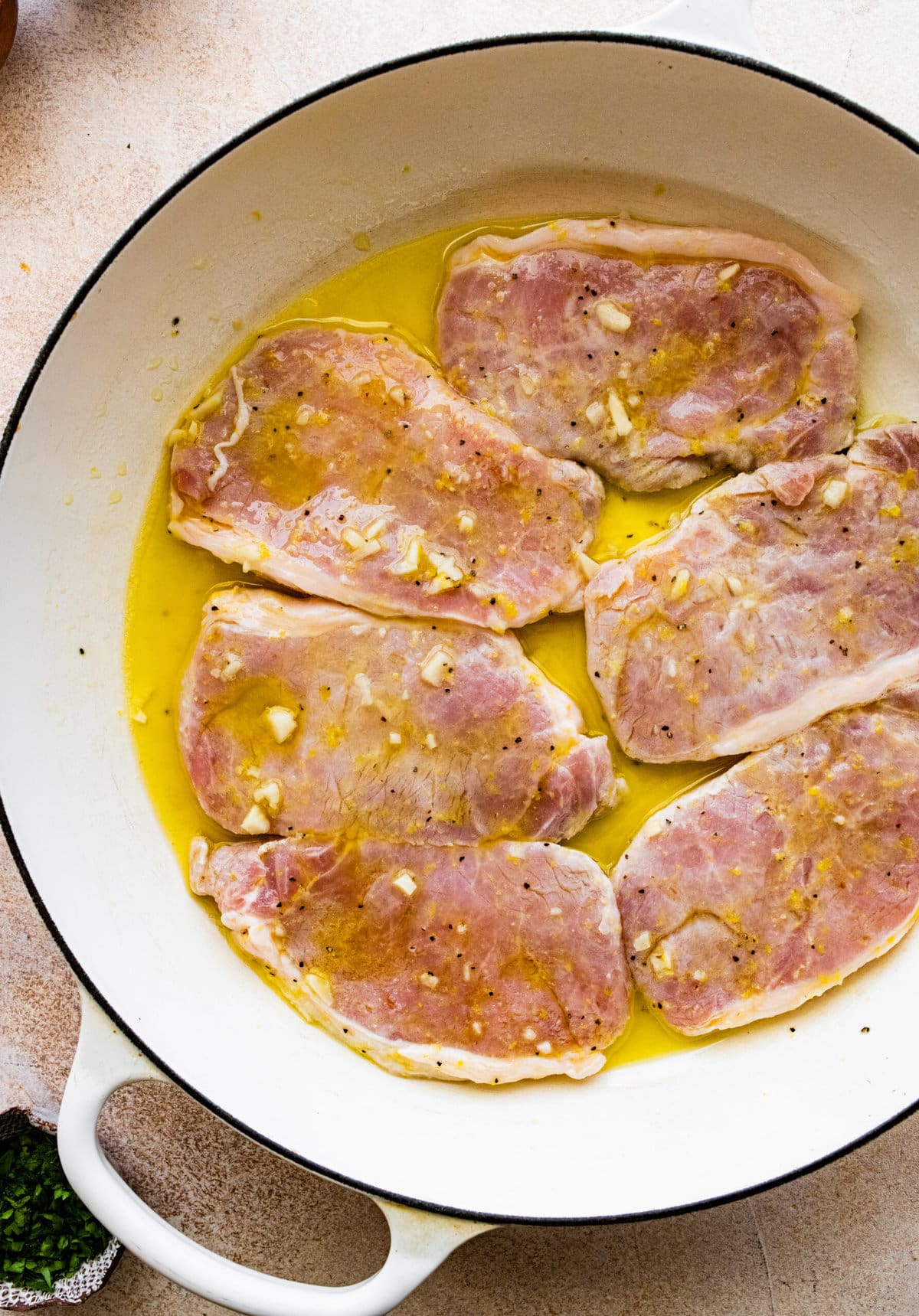How to Make Best Juicy Thin Pork Chops Step by Step: cooking the pork chops in butter and olive oil.
