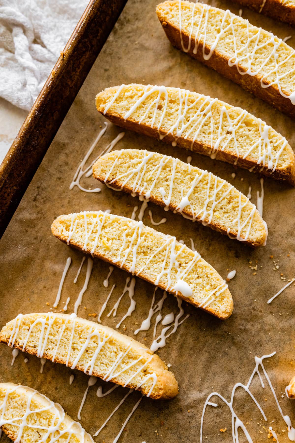 lemon biscotti with lemon glaze on parchment paper.