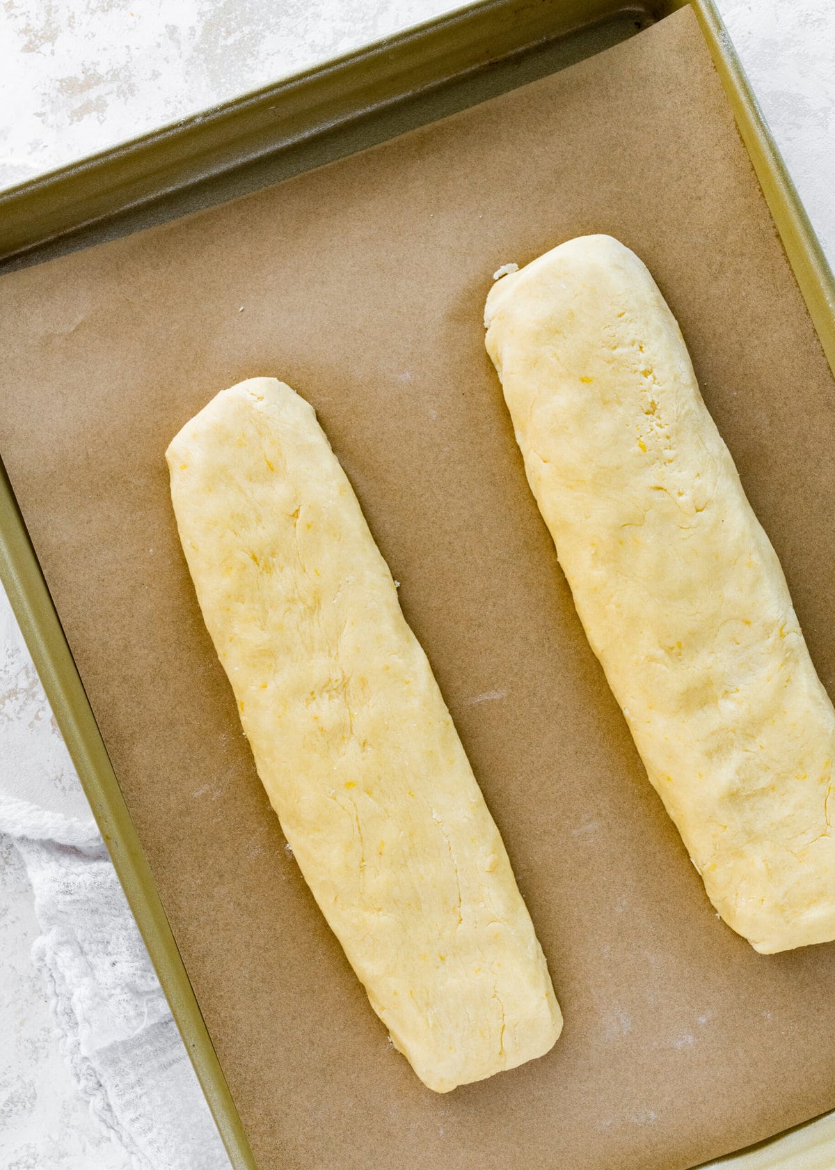 How to make Best Lemon Biscotti Recipe Step-by-Step: shaping two logs on a lined baking sheet.