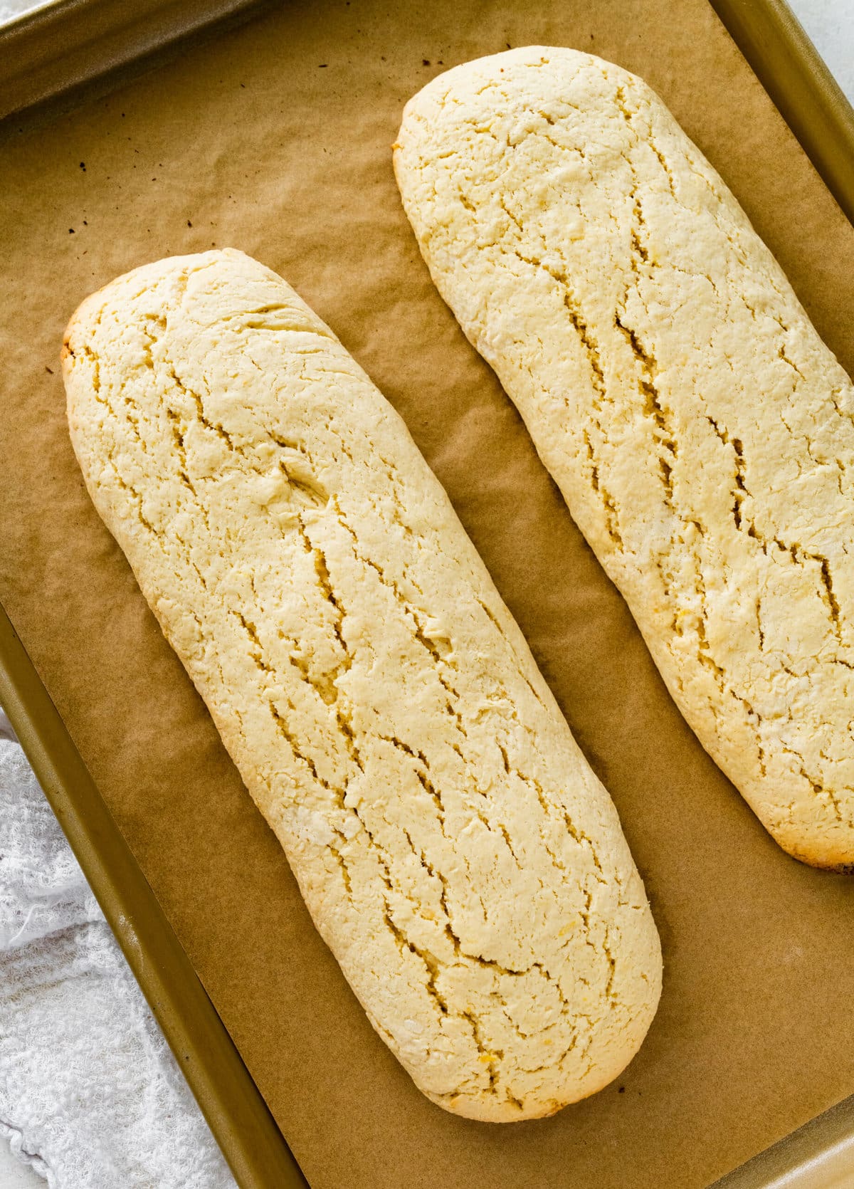 How to make Best Lemon Biscotti Recipe Step-by-Step: cookie logs after the first bake.