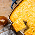taking out a slice of the best sweet cornbread on with a spatula.