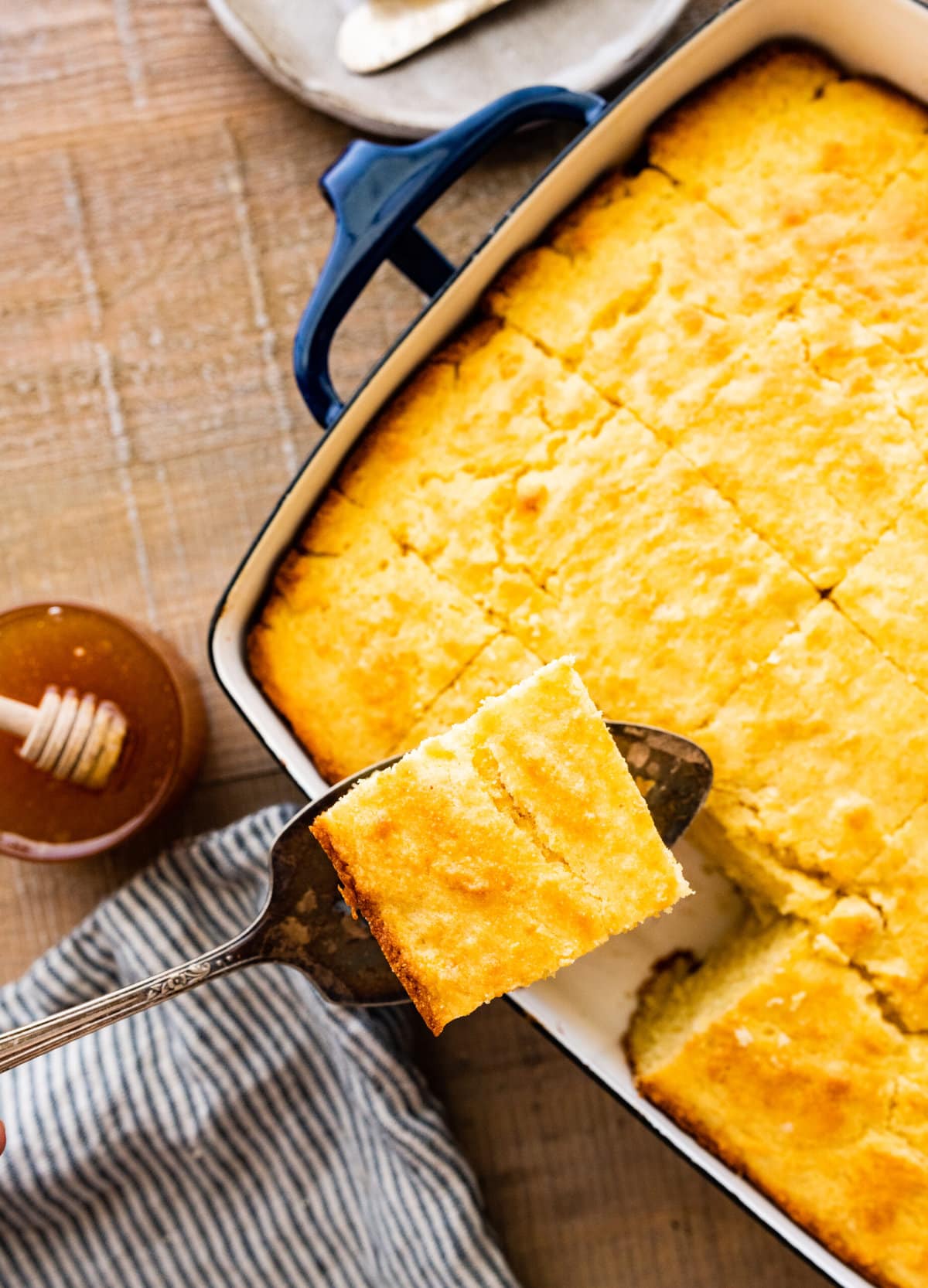 taking out a slice of the best sweet cornbread on with a spatula.