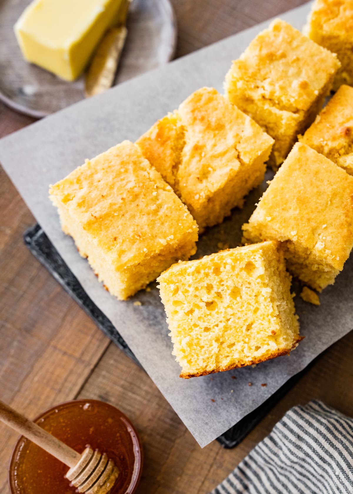 plated square slices of the best sweet cornbread recipe. Thick and airy slices on a plate.