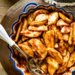 Easy baked cinnamon apples in a pie plate with blue rim.