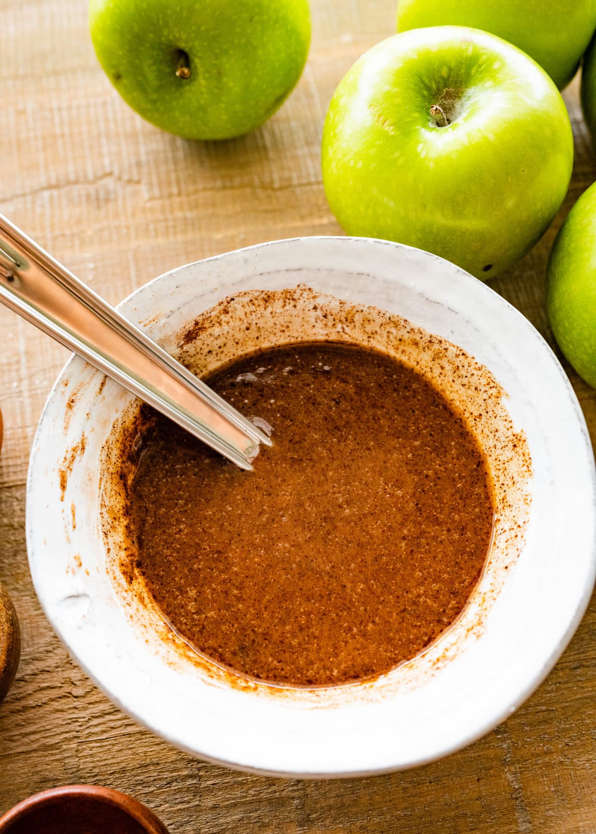 How to make easy baked cinnamon apples- step-by-step: mixing spices and butter in a bowl until well combined.