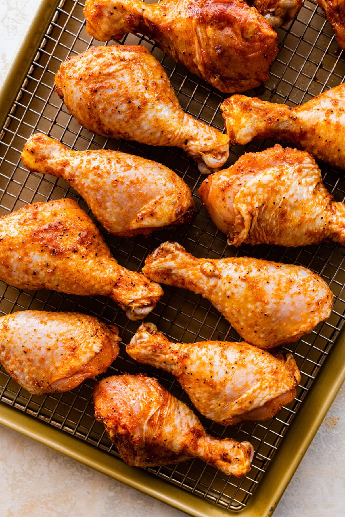 How Long to Bake Chicken Drumsticks at 400- placing the drumsticks on a sheet pan with the wore rack on top.