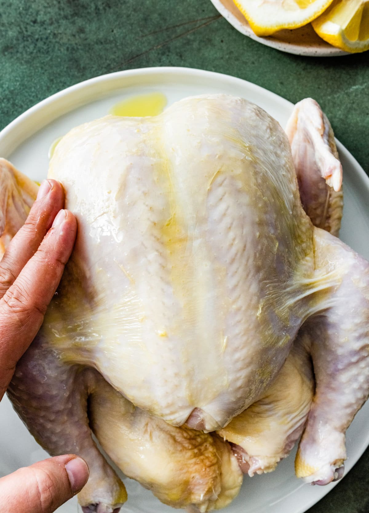 How Long to Cook Whole Chicken Recipe Perfect & Juicy (step-by-step instructions)- rubbing with olive oil.