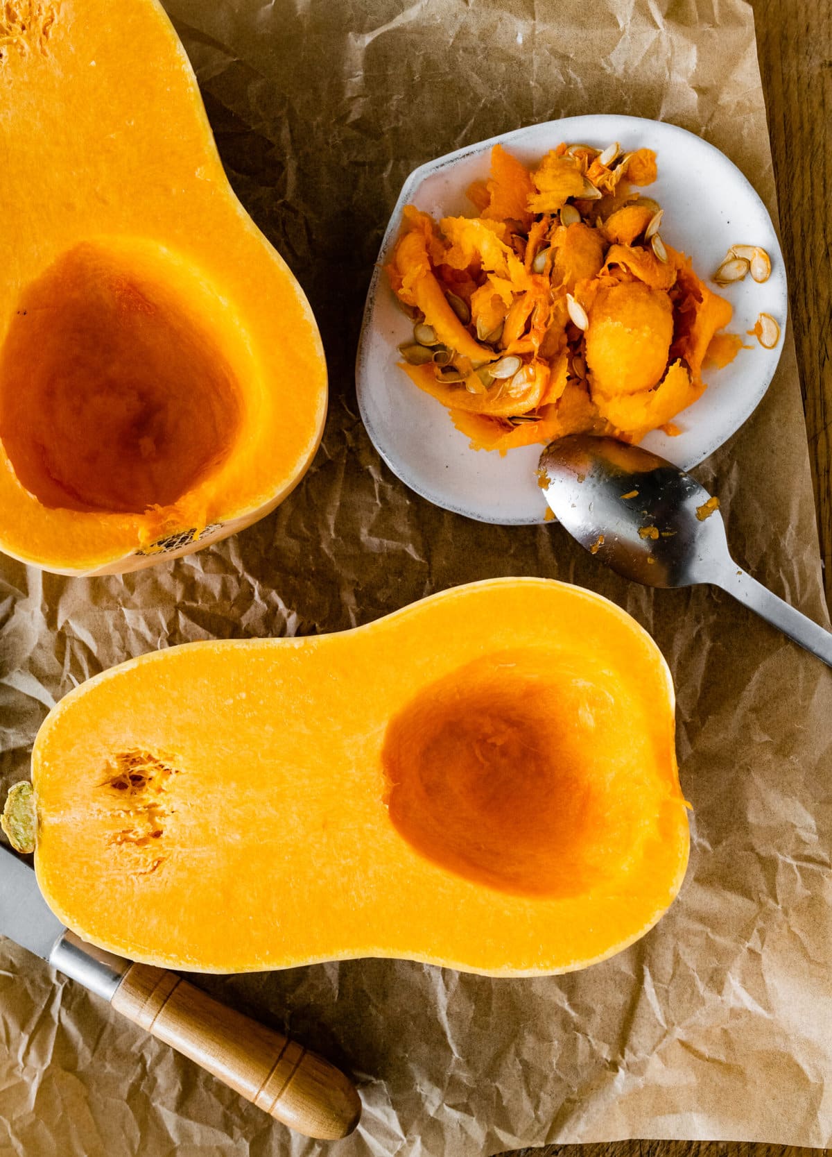 How to Cook Butternut Squash Whole in Oven Recipe- scooping out the insides.