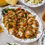 Slices of baked chicken breast on a tray.