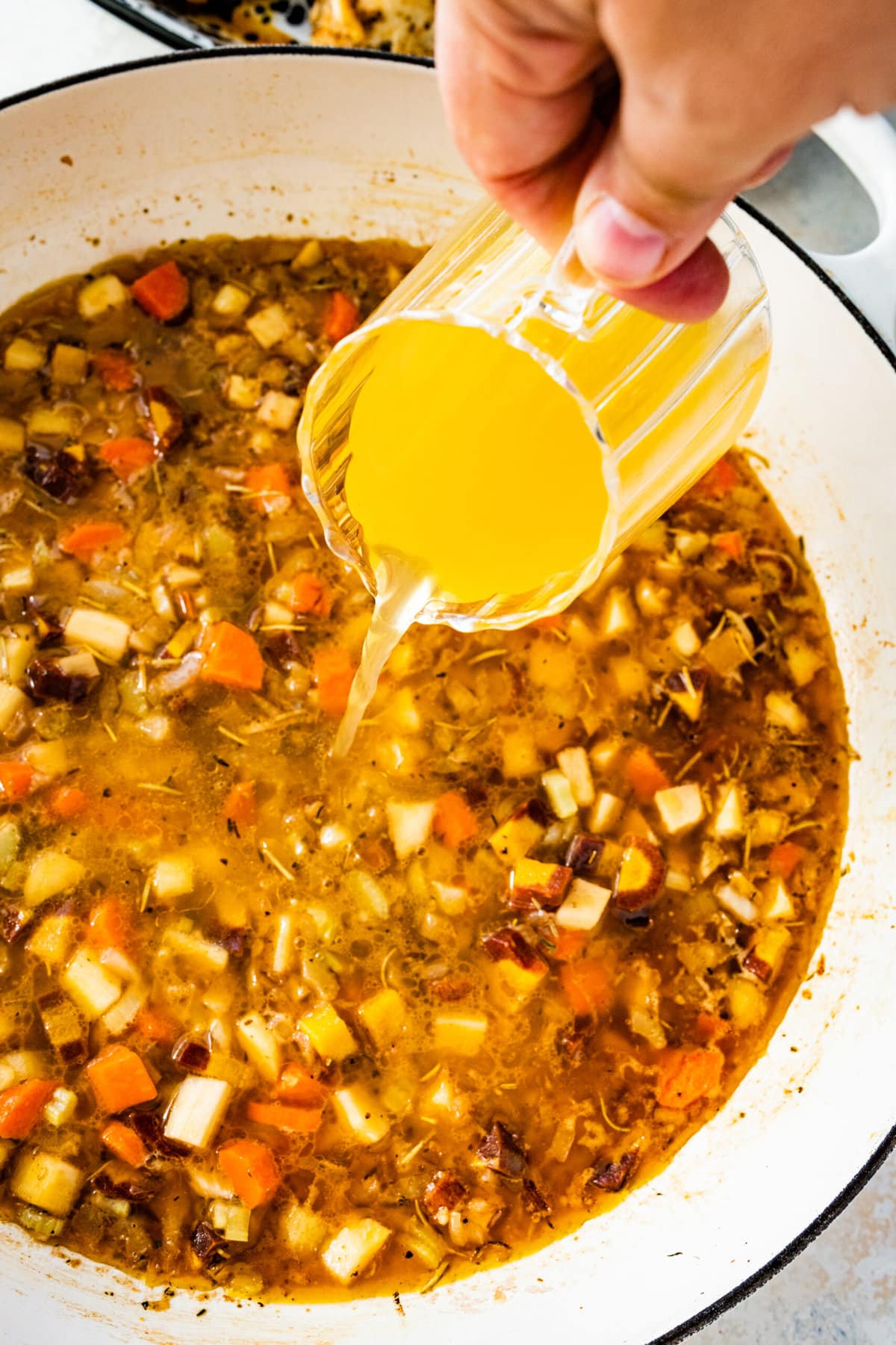 How to make Juicy Oven baked Chicken Breast Recipe: adding broth to the veggies.