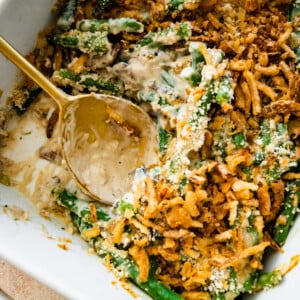 Serving spoon in a dish of green bean casserole recipe with fresh green beans no soup.
