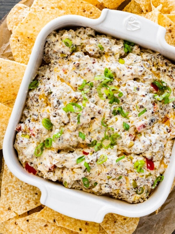 Bowl of sausage cream cheese dip surrounded by tortilla chips.