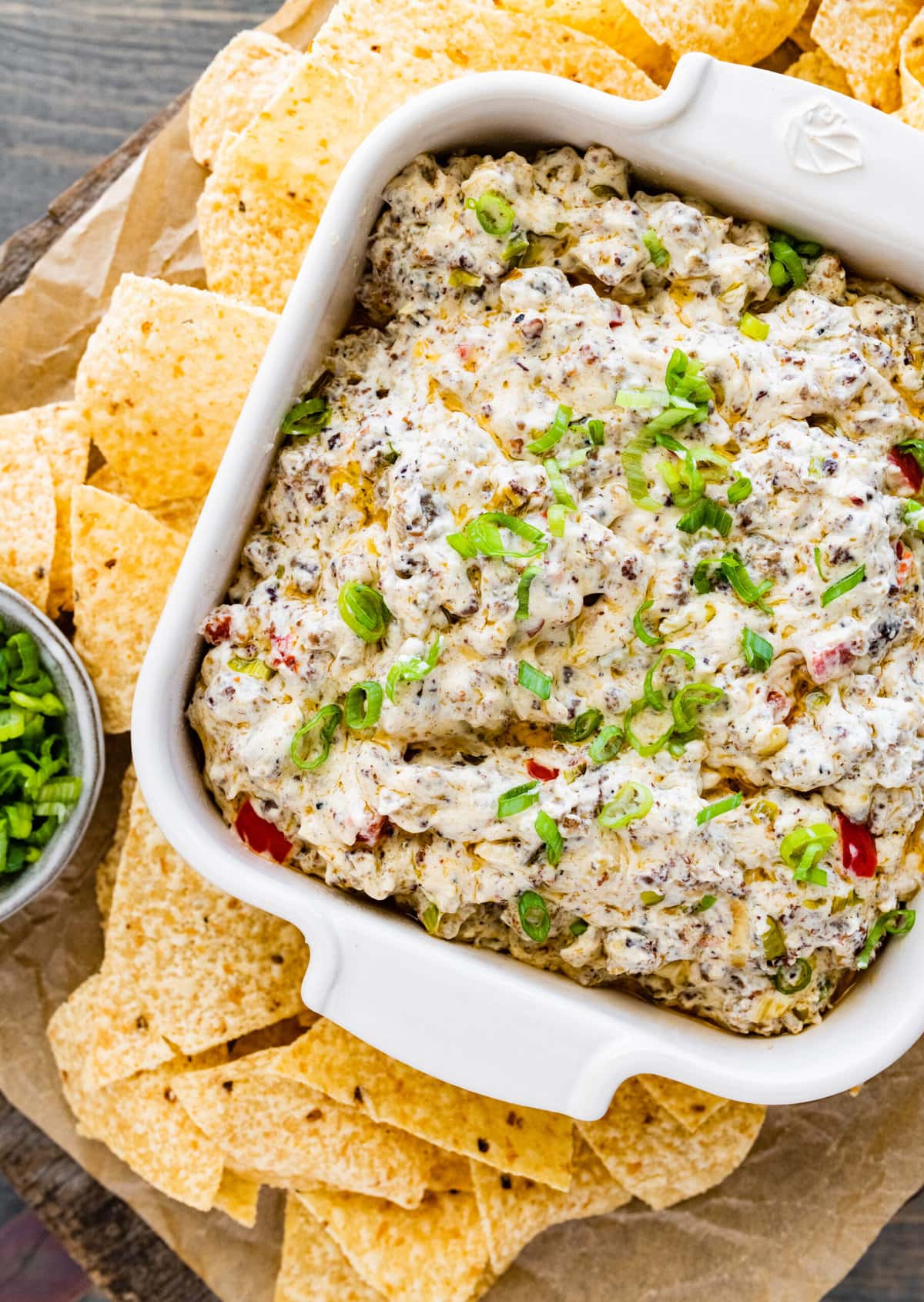 Best Jimmy Dean Sausage dip in a white serving dish with chips surrounding the dish.