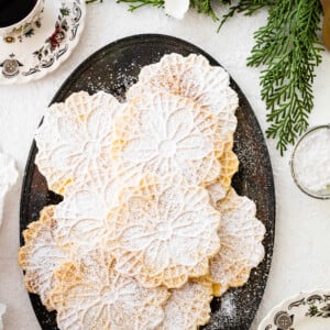 Freshly baked pizzelle cookies on a platter.