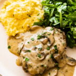 plate of steak marsala (lots of creamy mushroom sauce over steak) with homemade polenta and green arugula salad.