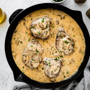 Steak marsala with mushrooms in a skillet.