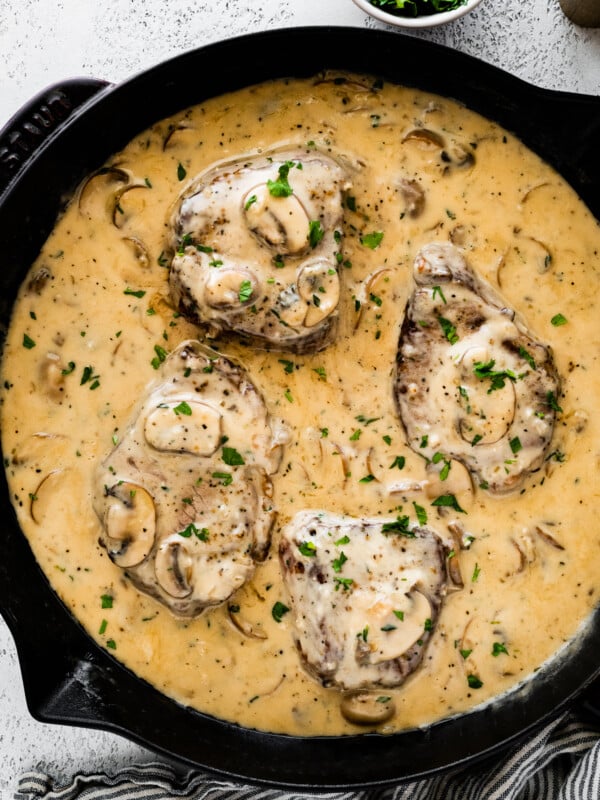 Steak marsala with mushrooms in a skillet.
