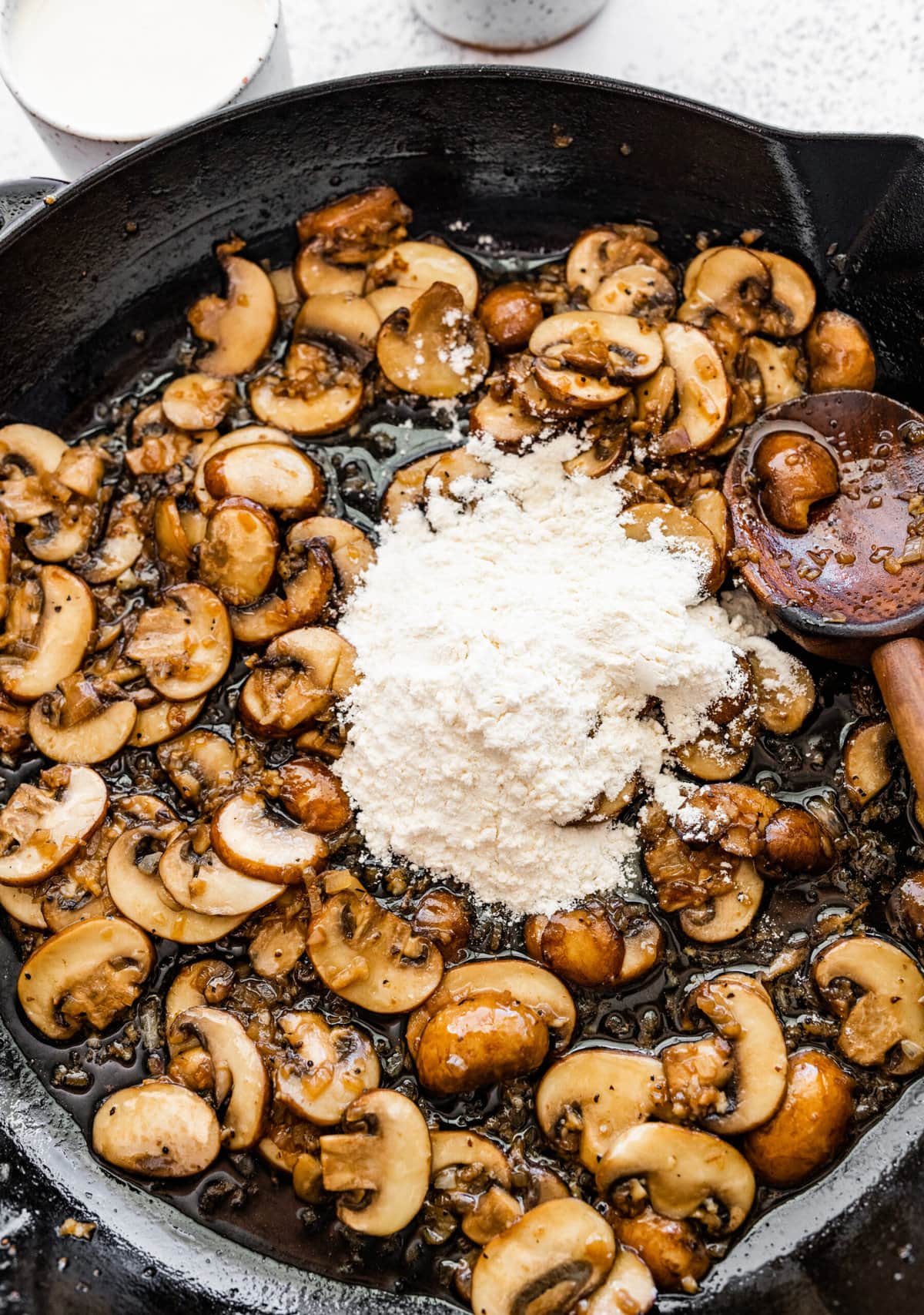 How to make best Steak Marsala recipe step-by-step: adding flour to cooked mushrooms to make roux.
