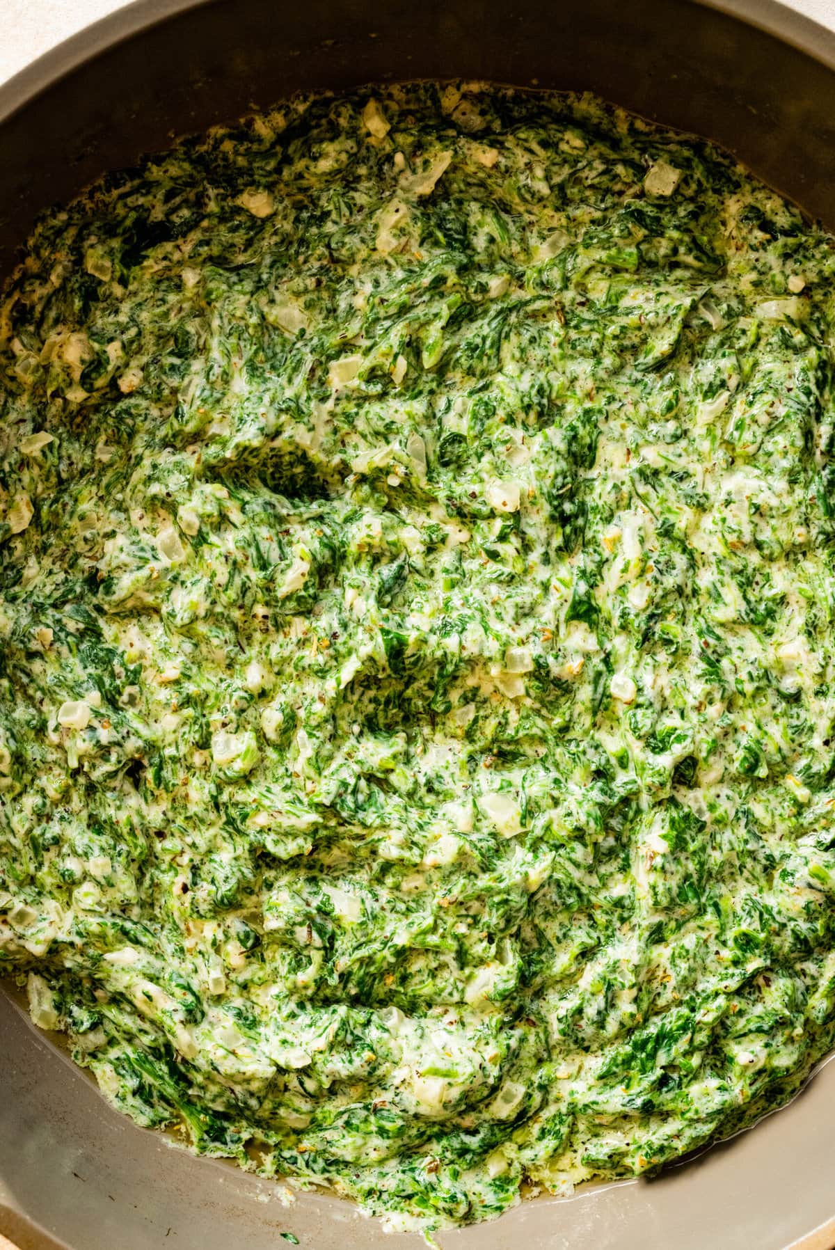 up close of steakhouse creamed spinach recipe in a pan.