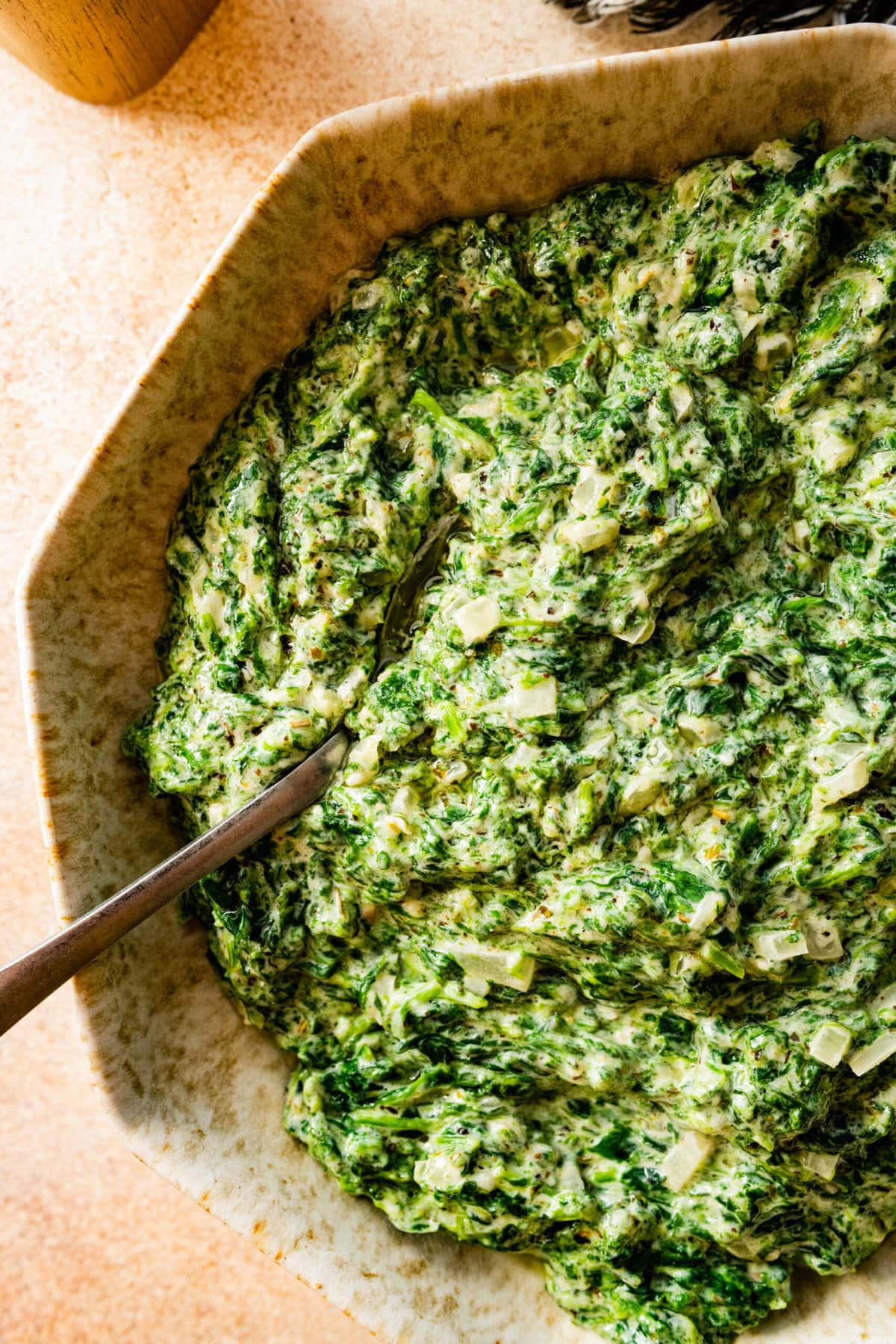 steakhouse creamed spinach recipe with a spoon in it. 