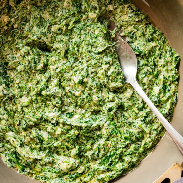 steakhouse creamed spinach recipe with a spoon in it.