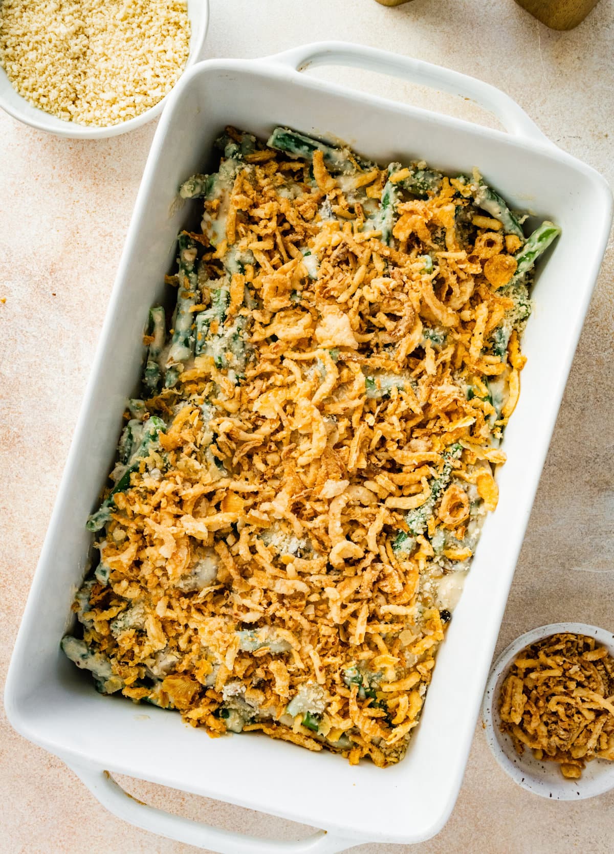 How to make Best Fresh Green Bean Casserole Recipe: topping the green beans with the onions and bread crumbs.