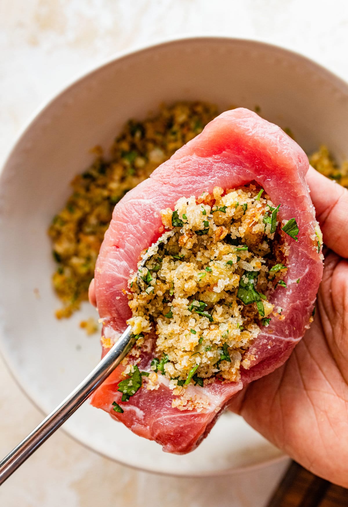 how to make Oven Baked Stuffed Pork Chops Recipe: filling the pork chop with the stuffing.