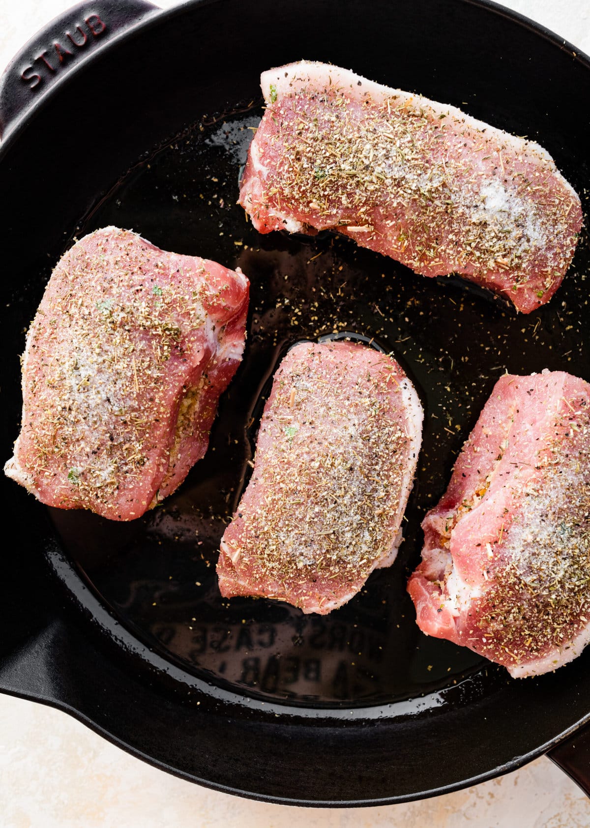 how to make Oven Baked Stuffed Pork Chops Recipe: Seasoned the outside of the pork chops and frying on cast iron skillet.