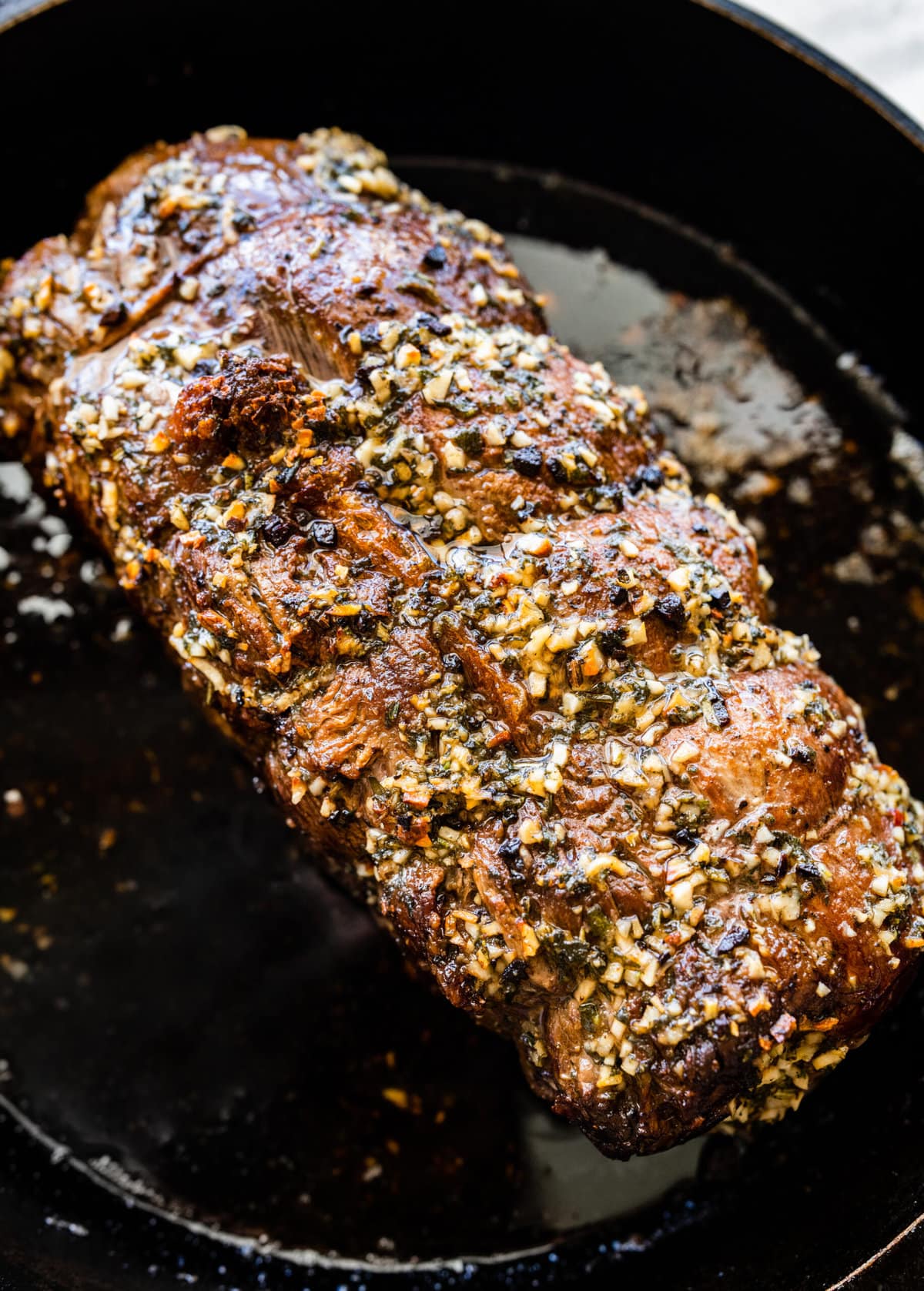 How to make perfect roast beef tenderloin- putting the marinade on the meat. Tenderloin after baking in the oven.