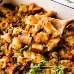 close up of stuffing on a wooden spoon ready to serve.