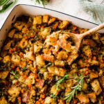 close up of stuffing on a wooden spoon ready to serve.
