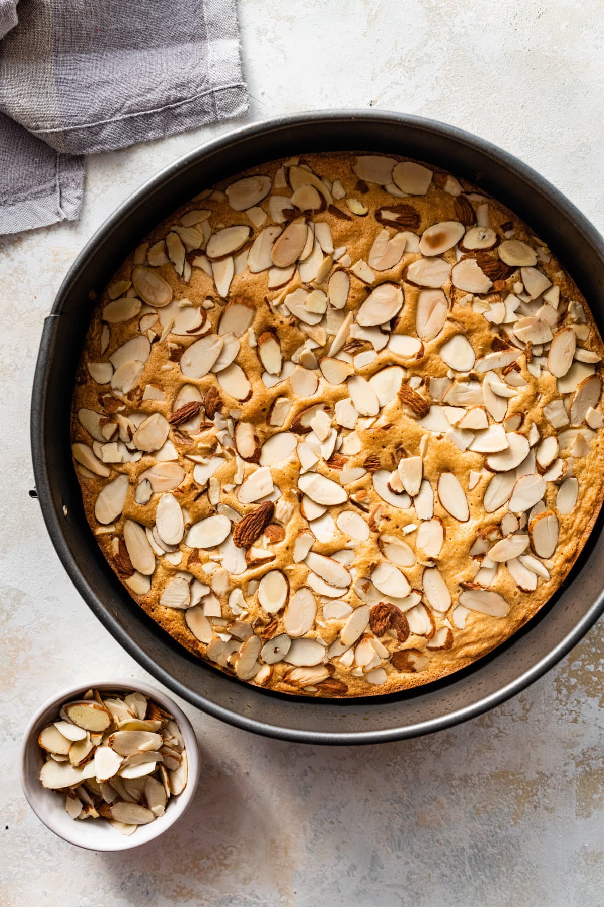 How to make easy almond cake recipe step by step: cake after it is baked in the pan.