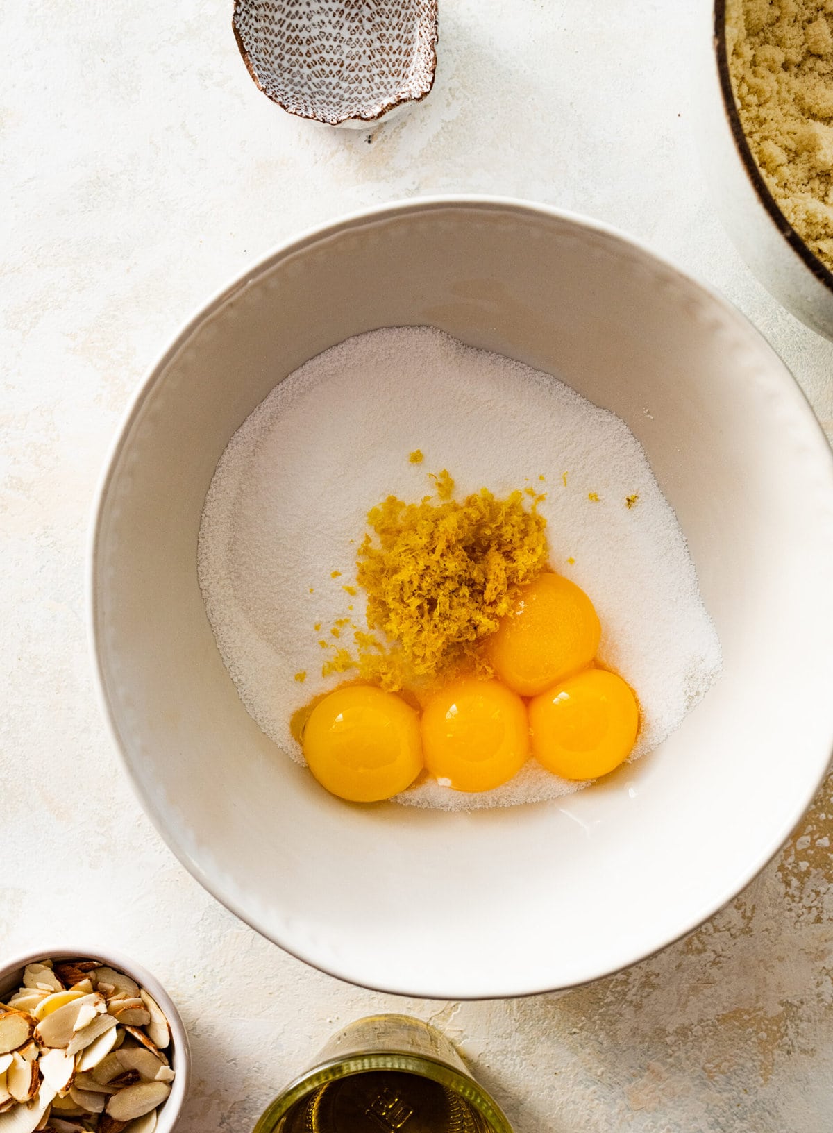 How to make easy almond cake recipe step by step: mixing the wet ingredients in a bowl.