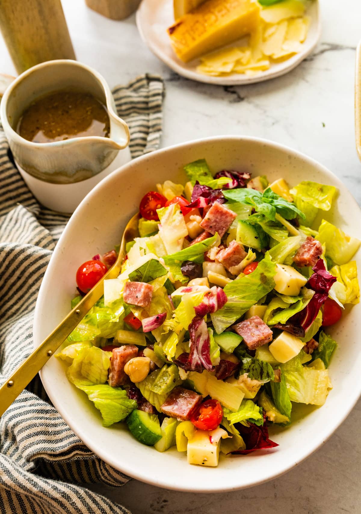 bowl of Italian chopped salad with dressing on the side.